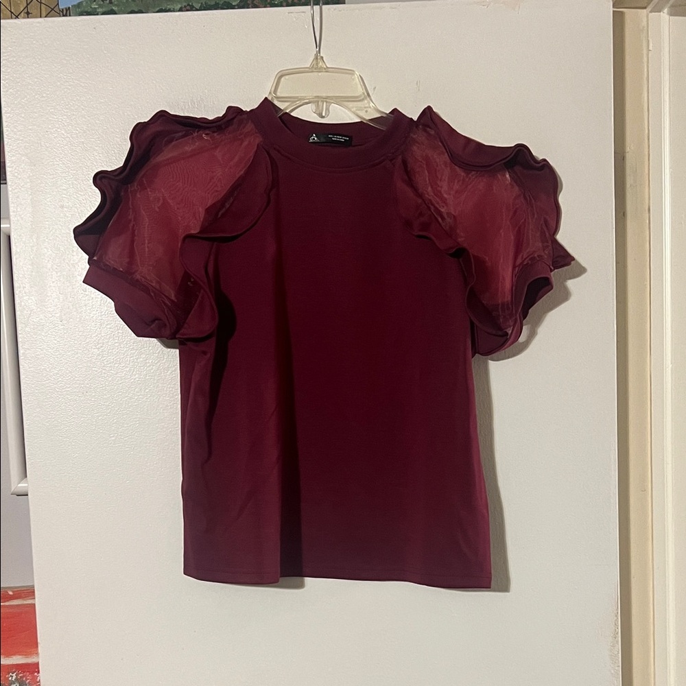 Anewsta wine color short sleeve top. Sheer sleeves with ruffle detail